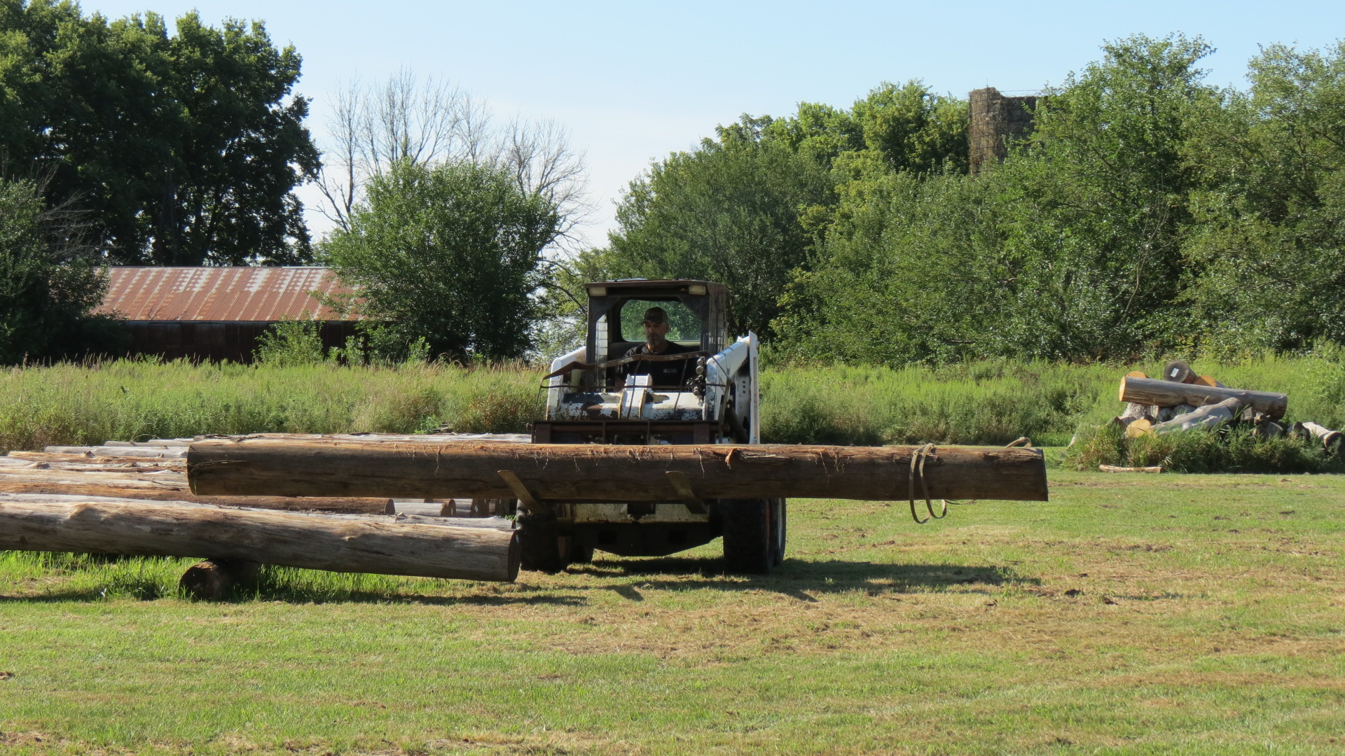 Moving logs in the lay-down area.