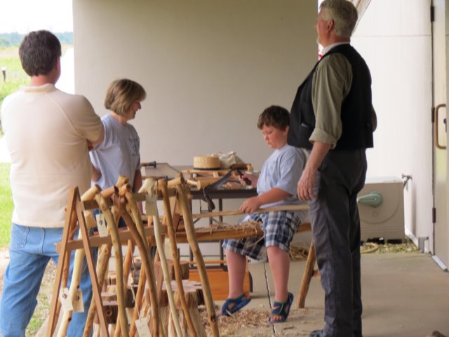 edagainbecomestheteacherasayoungstersitsontheshavingbenchheisholdingthedrawknife.jpg